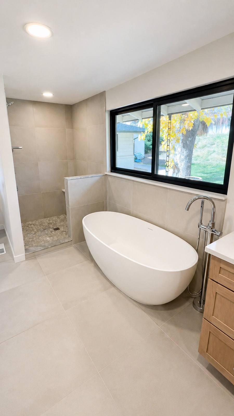 Freestanding tub by a bright window